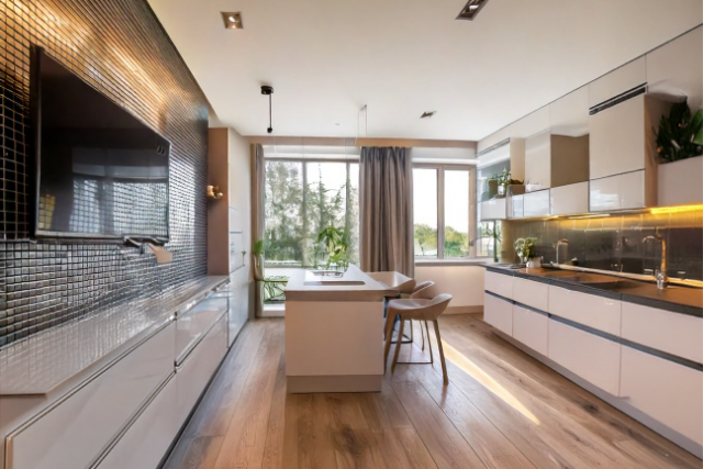 Condo interior featuring tiled walls and windows and TV